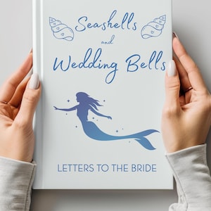 May include: A white book titled "Seashells and Wedding Bells" with blue seashell illustrations and a mermaid silhouette. The text "Letters to the Bride" is also visible. The book is held by a person.
