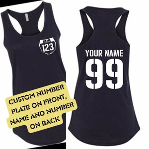 May include: Navy blue racerback tank top with a white graphic on the front that says "NAME 123". The back of the tank top has the text "YOUR NAME" above the number "99". A yellow sign says "CUSTOM NUMBER PLATE ON FRONT, NAME AND NUMBER ON BACK".