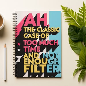 May include: A black spiral bound notebook with a colorful design and the text "AH, THE CLASSIC CASE OF TOO MUCH TIME AND NOT ENOUGH FILTER".