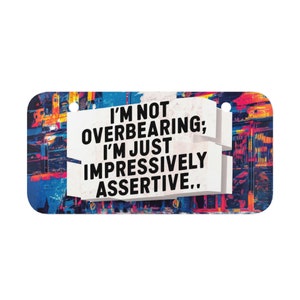 May include: A colorful, abstract background with a white rectangle in the center. The rectangle contains the text "I'm not overbearing; I'm just impressively assertive."