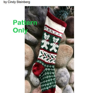 May include: Knitted Christmas stocking with a red, white, and green pattern featuring two teddy bears. The stocking is hanging on a rock wall. The text "Pattern Only" is superimposed on the image.