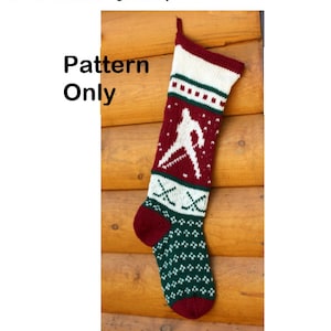 May include: A red and green knitted Christmas stocking with a white hockey player design. The stocking is hanging on a wooden wall. The text "Pattern Only" is written in white on a black background.