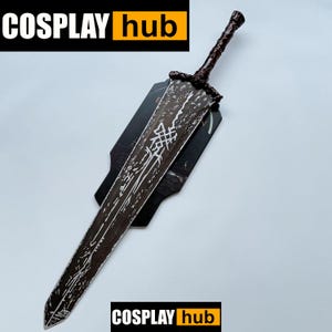 May include: A large, dark brown sword with intricate white markings and a textured handle. The blade is displayed on a black stand. The image includes the text "COSPLAY hub" in white letters on a black background with an orange square.
