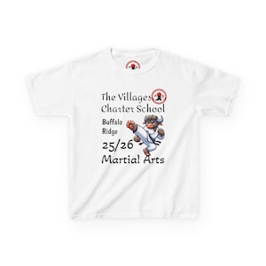 May include: White t-shirt featuring the text "The Villages Charter School Buffalo Ridge 25/26 Martial Arts." A cartoon bull in a karate uniform is kicking. A small logo is at the top and center of the shirt.