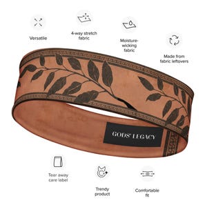 May include: A terracotta-colored headband with a dark brown leaf design and the text "GODS' LEGACY." The headband is made of 4-way stretch and moisture-wicking fabric. It is a versatile, trendy product with a comfortable fit.