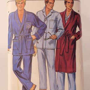 May include: Vintage Butterick sewing pattern featuring illustrations of men's sleepwear. The designs include a blue robe and pajama set, striped pajamas, and a burgundy robe. The pattern size is (L-XL).
