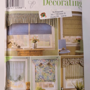 May include: A Simplicity Home Decorating sewing pattern envelope, number 8353, featuring illustrations of various window treatments including roman shades, valances, and curtains with floral, striped, and solid fabric designs for home interiors.