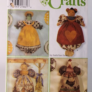 May include: A Simplicity Crafts sewing pattern envelope 8238 featuring four fabric doll designs by Faith Van Zanten. The illustrations show dolls dressed in various outfits including a yellow apron, a red heart dress, and a rooster print dress.