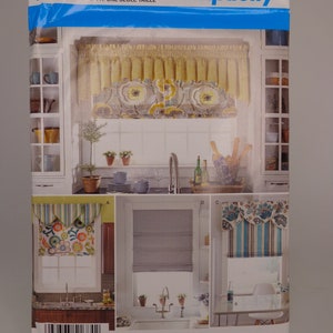 May include: Simplicity sewing pattern number 1684 OS, featuring three different window treatment designs. The first design is a yellow and white floral valance, the second is a striped valance with a scalloped edge, and the third is a blue and white floral valance with a striped bottom.