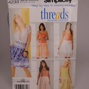 May include: A sewing pattern package for a skirt, featuring four different styles. The package is green and white with the text "Simplicity" and "threads Magazine Collection".