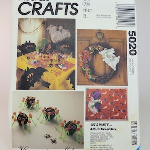 May include: A McCall's Crafts pattern for Halloween decorations. The pattern includes instructions for making a ghost wreath, a spider web table runner, and spider candy holders. The pattern number is 5020.