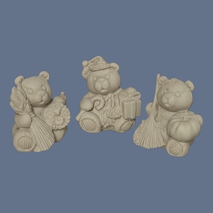 May include: Three unpainted ceramic bear figurines. The left bear holds a corn stalk and a wreath. The center bear wears a Santa hat and holds a gift box. The right bear holds a broom and a pumpkin. Each bear has textured fur details.