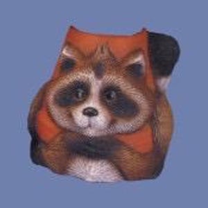 May include: A decorative figurine shaped like a raccoon with brown and black fur, wearing a bright orange vest. The raccoon has a white muzzle, dark eye patches, and a small black nose, with its front paws tucked inward against its chest.