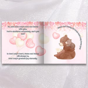 The image is a book page with a pink background and heart-shaped balloons. The page contains text and illustrations, including a heart-shaped balloon with the words "Love" and a brown bear holding a baby.