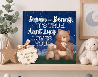 May include: A square hardcover book with a dark blue night sky background featuring white stars and three brown bears. The text reads: Susan AND Benny, IT'S TRUE! AUNT LUCY LOVES YOU! A light tan gift tag with a gold heart icon is attached to the book.
