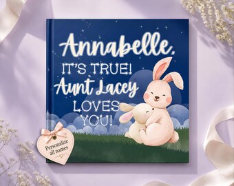 May include: A square hardcover book with a dark blue night sky background featuring white stars and clouds. The text reads Annabelle. IT'S TRUE! Aunt Lacey LOVES YOU! Two light pink rabbits are hugging. A heart-shaped tag says Personalize all names.
