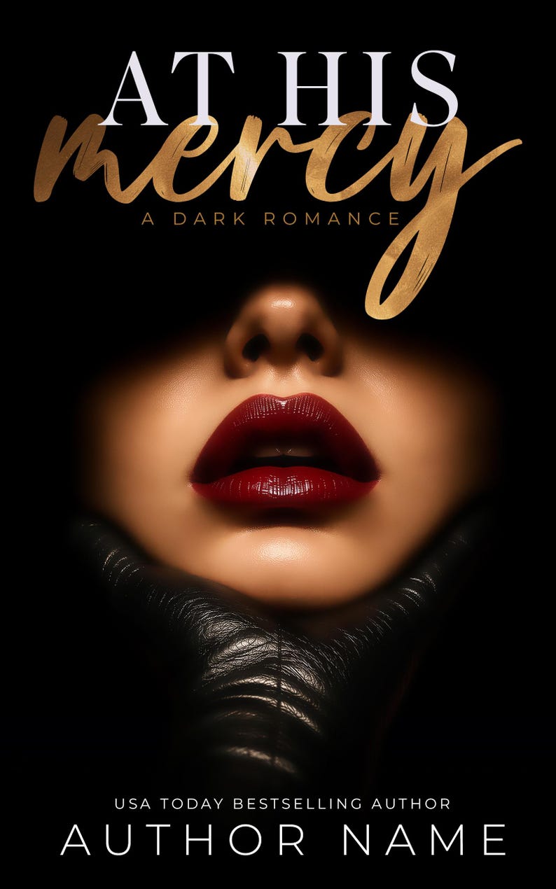 May include: Book cover with the title "AT HIS mercy" in gold script over a woman's face with dark red lipstick. The words "A DARK ROMANCE" are below the title. The author's name is at the bottom.
