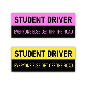 May include: Two rectangular stickers with the text "STUDENT DRIVER" in large, bold, black font. The top sticker has a pink top and black bottom, while the bottom sticker has a yellow top and black bottom. Both stickers read "EVERYONE ELSE GET OFF THE ROAD" in white font.