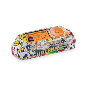 May include: A handheld electronic device with a sticker-covered exterior. The device features an orange button and a small screen displaying text and graphics. The device has a slot for a micro SD card. The device is white, orange, yellow, and black.