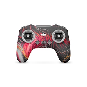 May include: A drone controller featuring an abstract pattern in black, red, and white. The controller has two joysticks, various buttons, and the DJI logo. The design resembles flowing paint, giving the device a distinctive appearance.