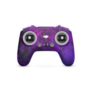 May include: A drone controller featuring a purple and black marbled design. The controller has two control sticks, several buttons, and the DJI logo. The design is a vibrant mix of colours, creating a unique and eye-catching look.