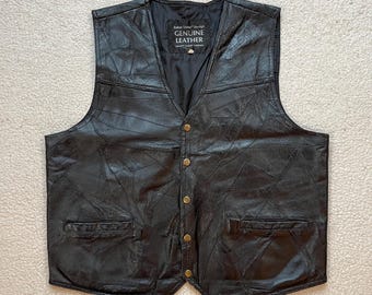 May include: A black leather waistcoat with a button-up front and two pockets. The waistcoat has a distressed look and features the text "Genuine Leather" on a label.