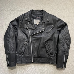 May include: Black leather motorcycle jacket with a diagonal zipper, quilted shoulder and elbow pads, and silver zippers. The jacket has a classic biker style with a notched collar and multiple pockets. The label reads "Open Road".