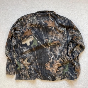 May include: A brown, green, and tan camouflage fleece jacket with a zipper closure.
