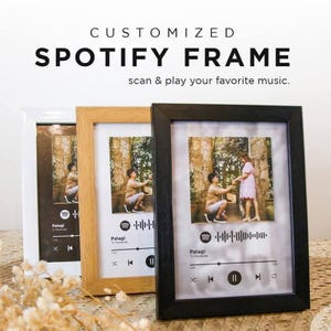 May include: Three framed photos with a Spotify interface design. The frames are white, light brown, and black. The photos feature a couple in a forest setting. Text on the frames reads "CUSTOMIZED SPOTIFY FRAME" and "scan & play your favorite music."