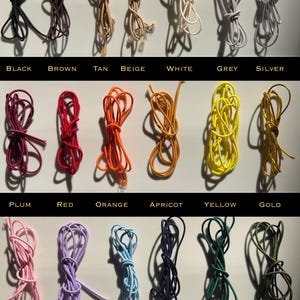 May include: A collection of colorful cords in various shades, including black, brown, tan, beige, white, grey, silver, plum, red, orange, apricot, yellow, gold, pink, purple, baby blue, dark blue, dark green, and olive. Each cord is labeled with its color.