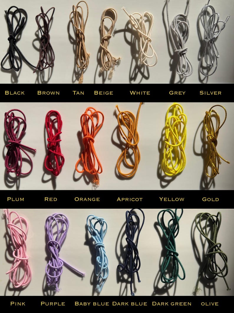 May include: A collection of colorful cords in various shades, including black, brown, tan, beige, white, grey, silver, plum, red, orange, apricot, yellow, gold, pink, purple, baby blue, dark blue, dark green, and olive. Each cord is labeled with its color.