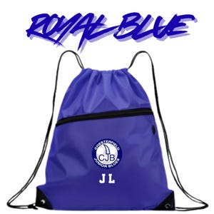 May include: A royal blue drawstring bag featuring black cord straps and a diagonal black zippered pocket. The front displays a circular logo with the text Chesterfield Junior Blues and CJB, with the letters JL printed in white below the logo.