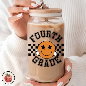 May include: A clear glass tumbler with a wooden lid and a black and orange design that says "FOURTH GRADE" with a smiley face with stars for eyes.