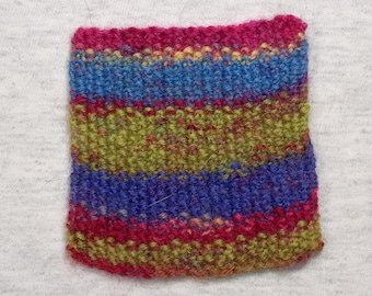 Tiny hand-knitted variegated wool blanket for miniature felt doll