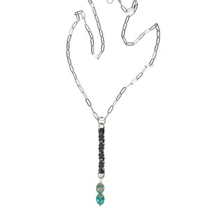 iron twist pendant with two turquoise stone drop on a stainless steel paperclip style chain with white background.