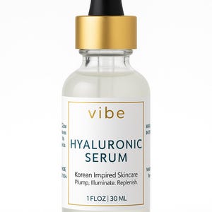 Peut inclure: Flacon en verre transparent de s&eacute;rum hyaluronique avec compte-gouttes noir et bouchon dor&eacute;. L'&eacute;tiquette indique "vibe HYALURONIC SERUM" et "1 FLOZ | 30 ML". Le produit est d&eacute;crit comme un soin de la peau d'inspiration cor&eacute;enne.