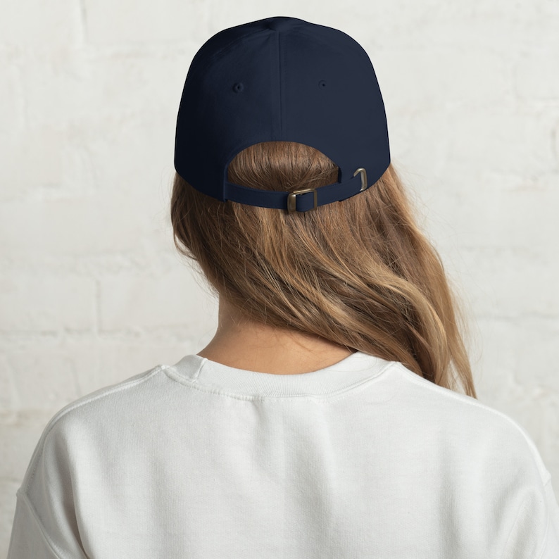May include: A navy blue baseball cap with an adjustable strap in the back.
