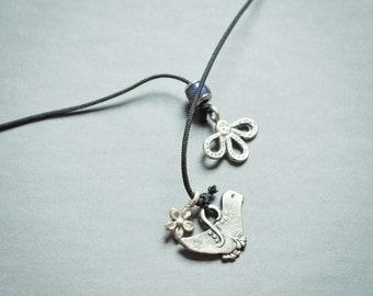 Folkloric storyteller tie-on necklace with pewter bird and mood bead