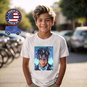 May include: White t-shirt with a blue and white illustration of a rapper with blue hair and a blue background. The rapper is wearing a black leather jacket and a silver chain.