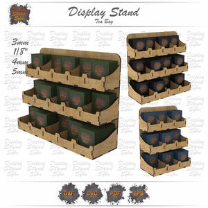 May include: A three-tiered wooden display stand for tea bags. The stand is made of light-colored wood and features multiple shelves with individual compartments. The text "Display Stand Tea Bag" is at the top. The stand is designed to hold tea bag boxes.