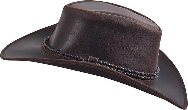 Puede incluir: Sombrero de vaquero de cuero marr&oacute;n con ala ancha y banda trenzada alrededor de la corona. El sombrero tiene un estilo western cl&aacute;sico. El sombrero es de cuero y es adecuado para actividades al aire libre.