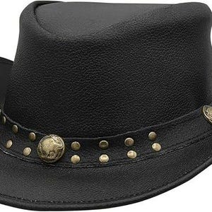 May include: Black cowboy hat with a slightly curved brim. The hat features a decorative band with brass-colored studs and two round, brass-colored medallions. The hat is made of a textured material, likely leather.