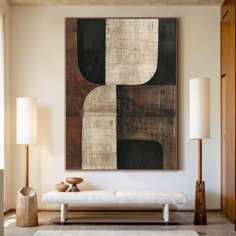 May include: Abstract geometric painting with curved shapes in shades of brown, black, and white. The painting has a textured surface and is framed.