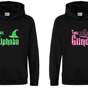Wicked movie hoodie, wicked hoodie, Cynthia Erivo, Elphaba, Ariana Grande, Glinda, kids adults, popular, defying gravity, Shiz university
