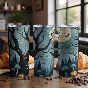 May include: Three stainless steel travel tumblers with a spooky Halloween design. Each tumbler features a dark tree, a full moon, bats, and mushrooms. The design is in shades of blue, black, and orange. The tumblers are cylindrical and have a silver lid.