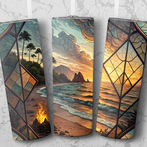 May include: Three stainless steel travel tumblers featuring a beach scene design. The artwork shows a sunset over the ocean, with palm trees, mountains, and a campfire. The design is framed by a stained glass effect.