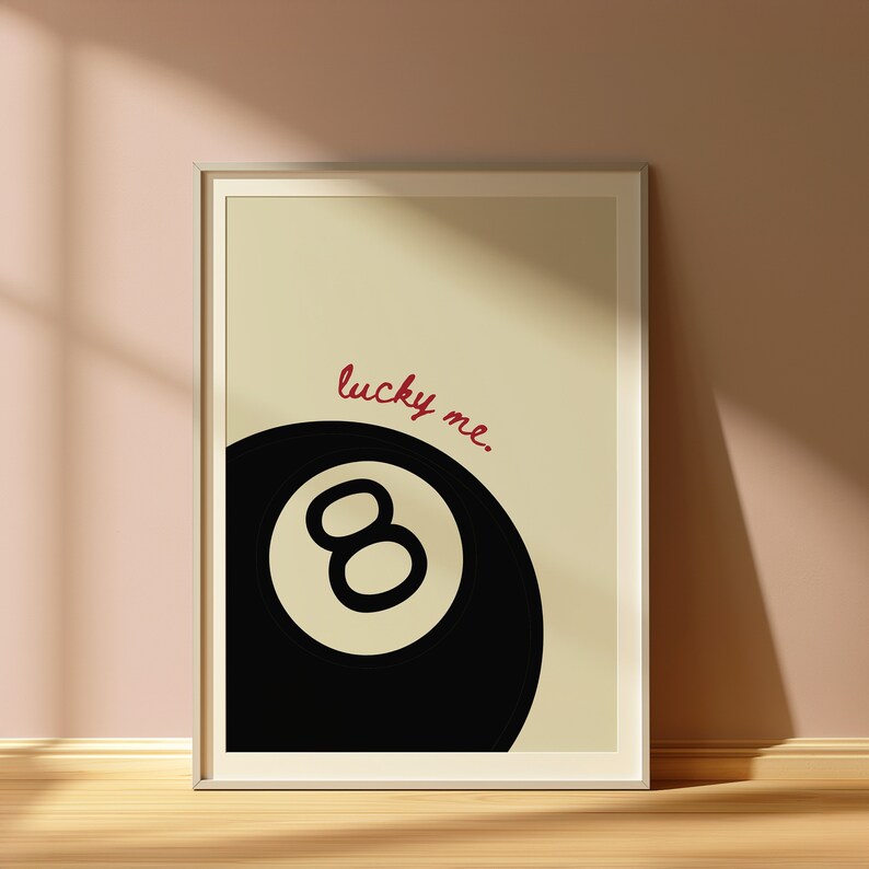 May include: A black and white illustration of a pool ball with the number eight on it. The text "lucky me." is written in red above the ball.