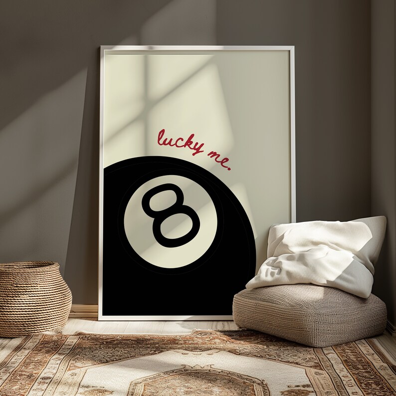May include: A black and white illustration of a pool ball with the number eight on it. The text "lucky me." is written in red cursive above the ball.