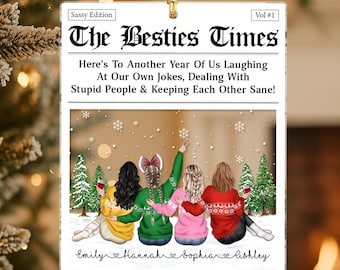 May include: A square Christmas ornament with a newspaper design. The headline reads "The Besties Times." The image shows four friends in winter attire, with text that reads "Here's To Another Year Of Us Laughing At Our Own Jokes, Dealing With Stupid People & Keeping Each Other Sane!"