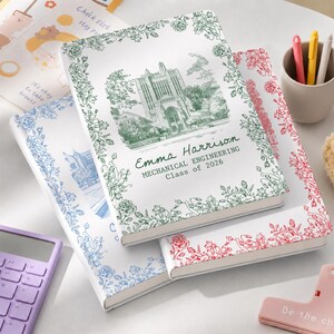 May include: Three personalized notebooks with floral borders. One notebook has a green floral border and a green illustration of a building with the text "Emma Harrison MECHANICAL ENGINEERING Class of 2026". The other notebooks have blue and red floral borders.